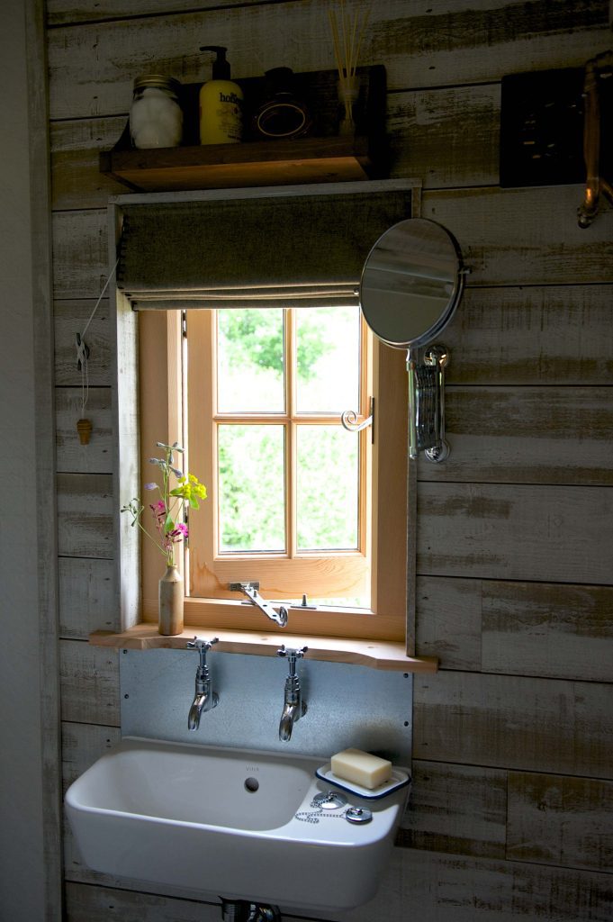 The bathroom sink and window inside on of Loose Reins' cabins