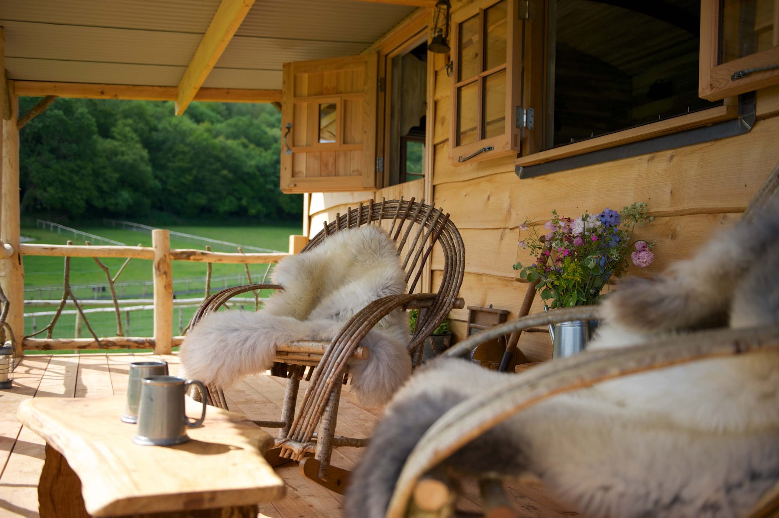 Rocking chairs with blankets on the Porch of a cabin at Loose Reins