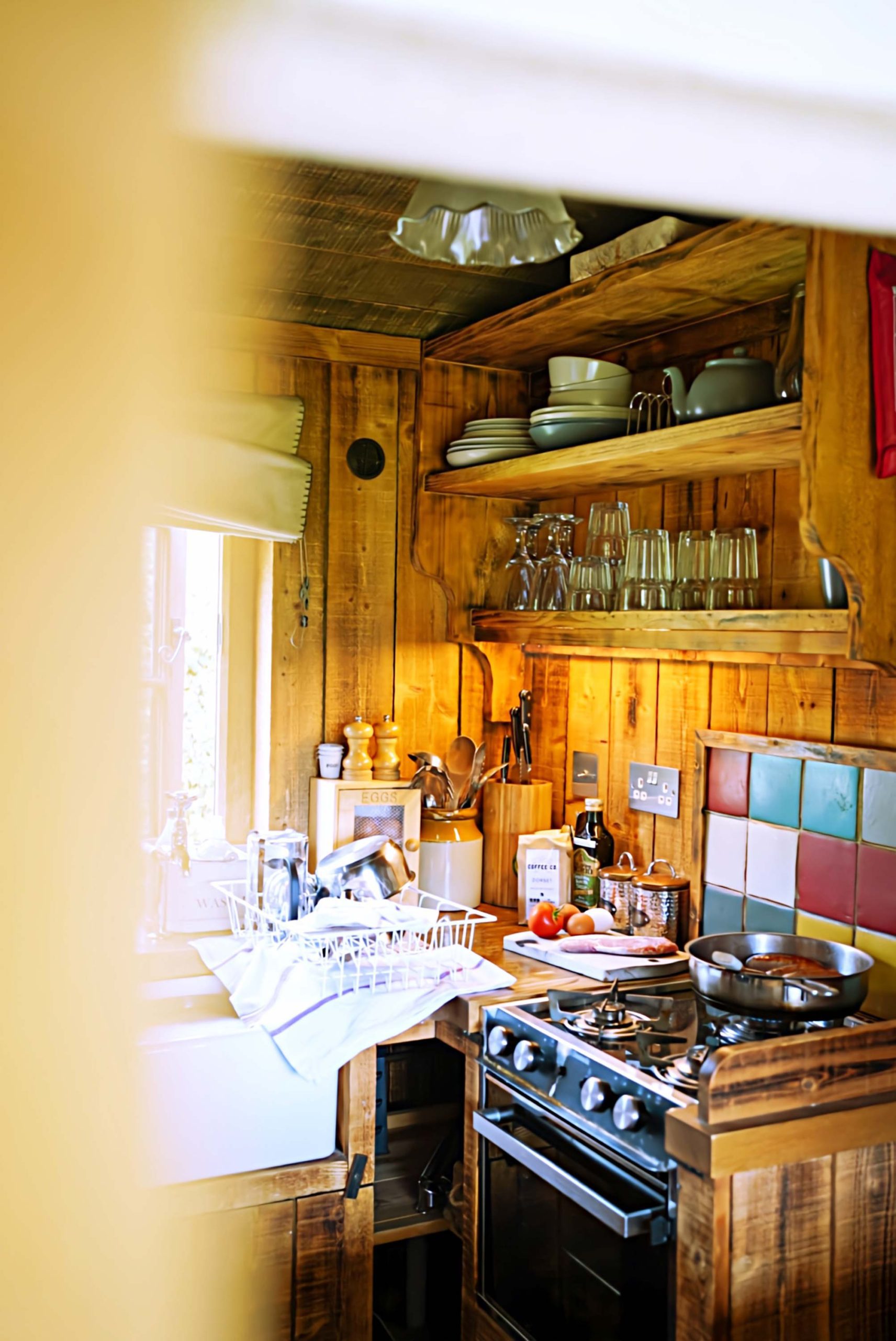 The kitchen in one of Loose Reins' cabins with food cooking on the hob