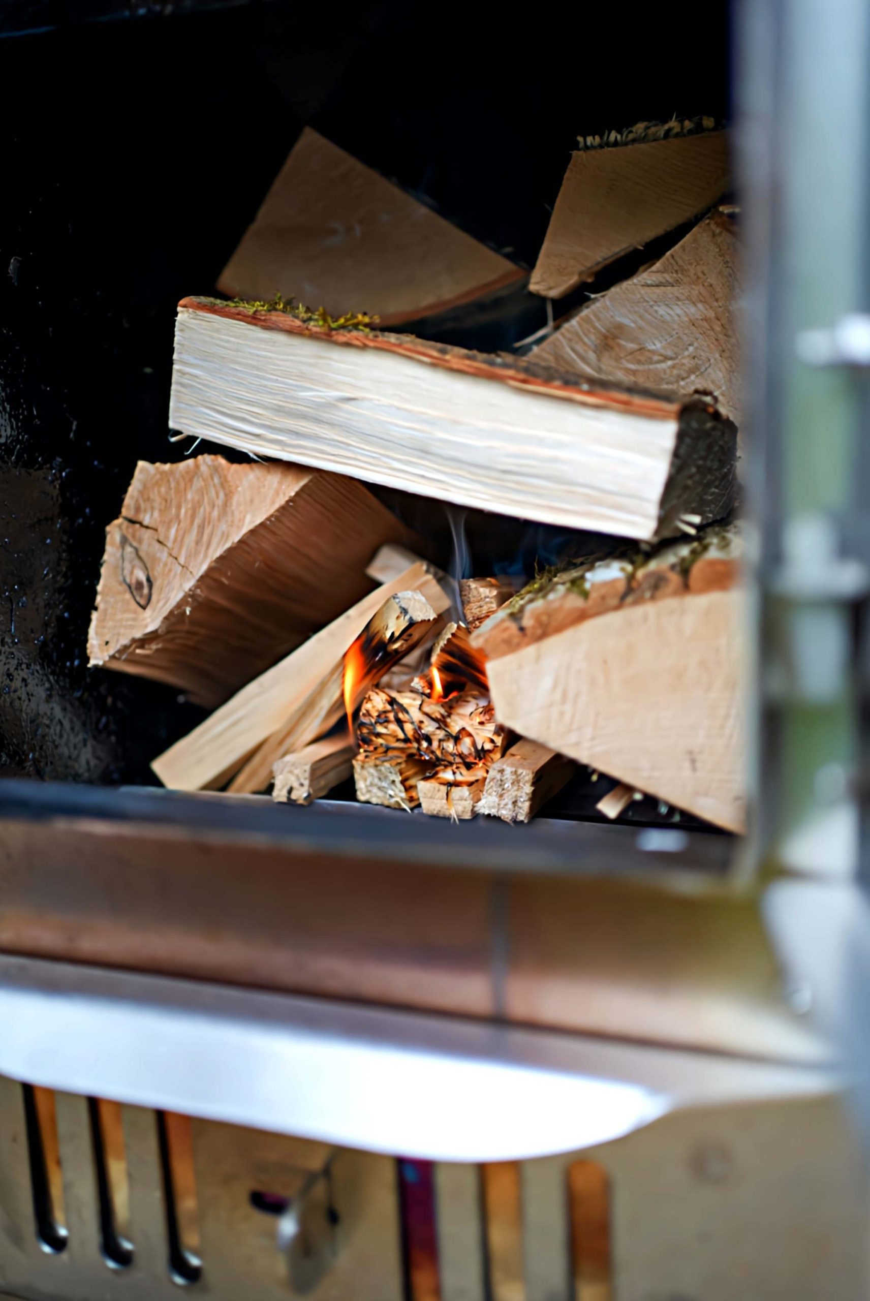 Logs inside the wood burner for one of Loose Reins' cabin's hot tubs