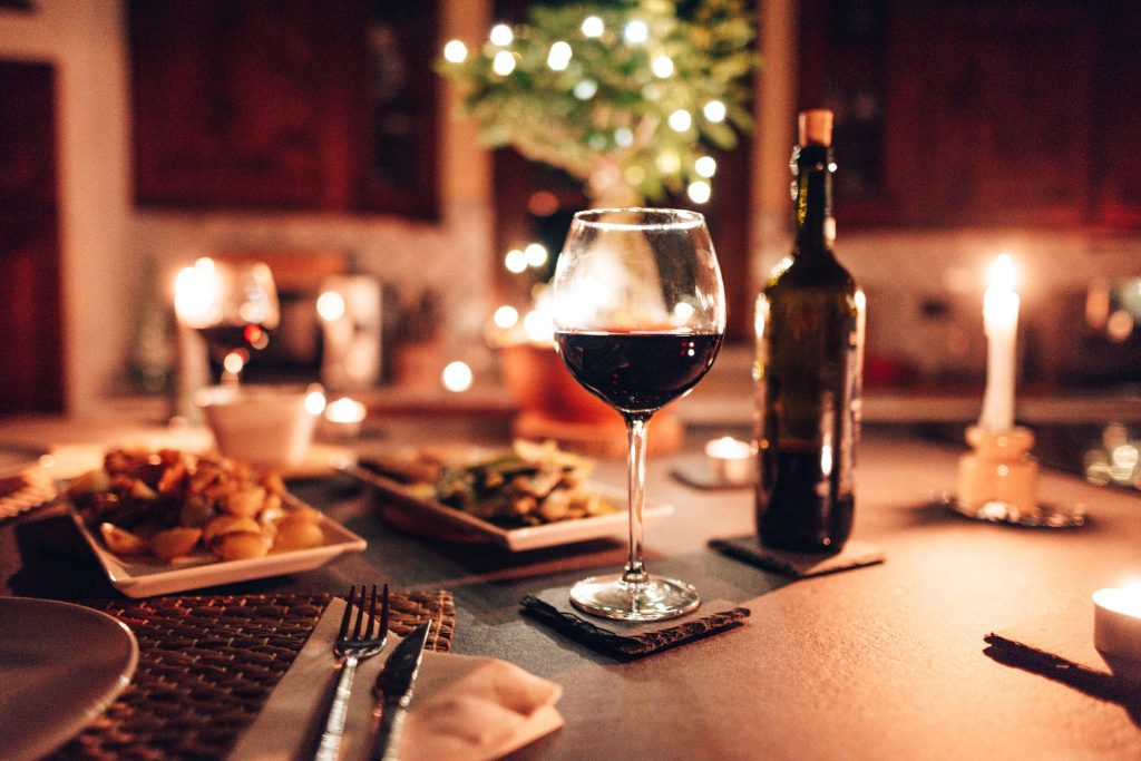 An evening meal and a bottle of wine on a table in a rustic restaurant
