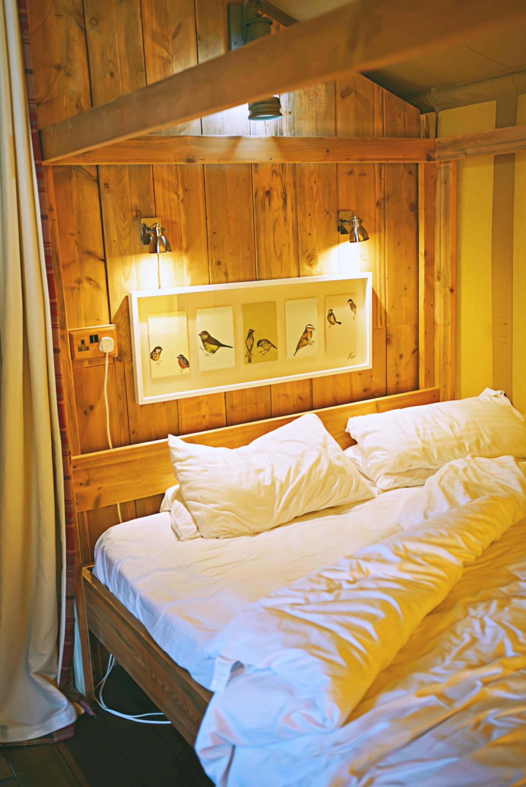 The king-size four poster bed in the main bedroom inside one of the Lodges at Loose Reins