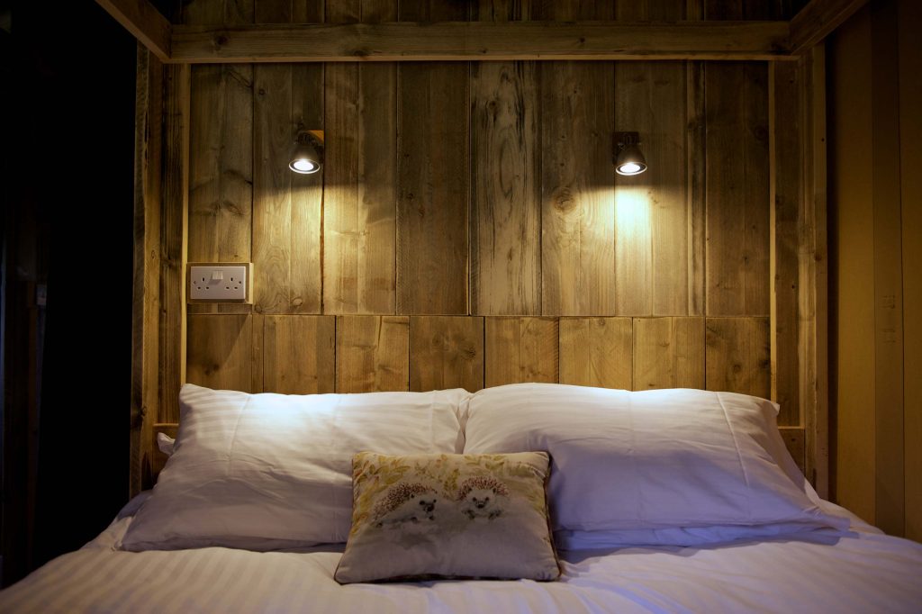 Pillows on the four poster bed in the main bedroom in one of the Lodges at Loose Reins