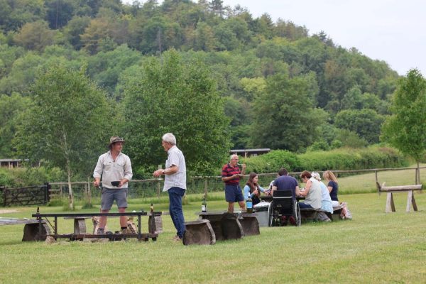 Family dining outdoors on holiday at Loose Reins in Dorset