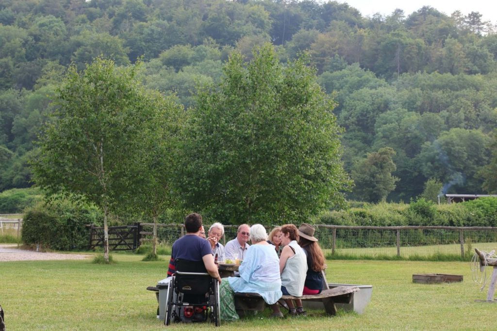 Family dining outdoors on holiday at Loose Reins in Dorset