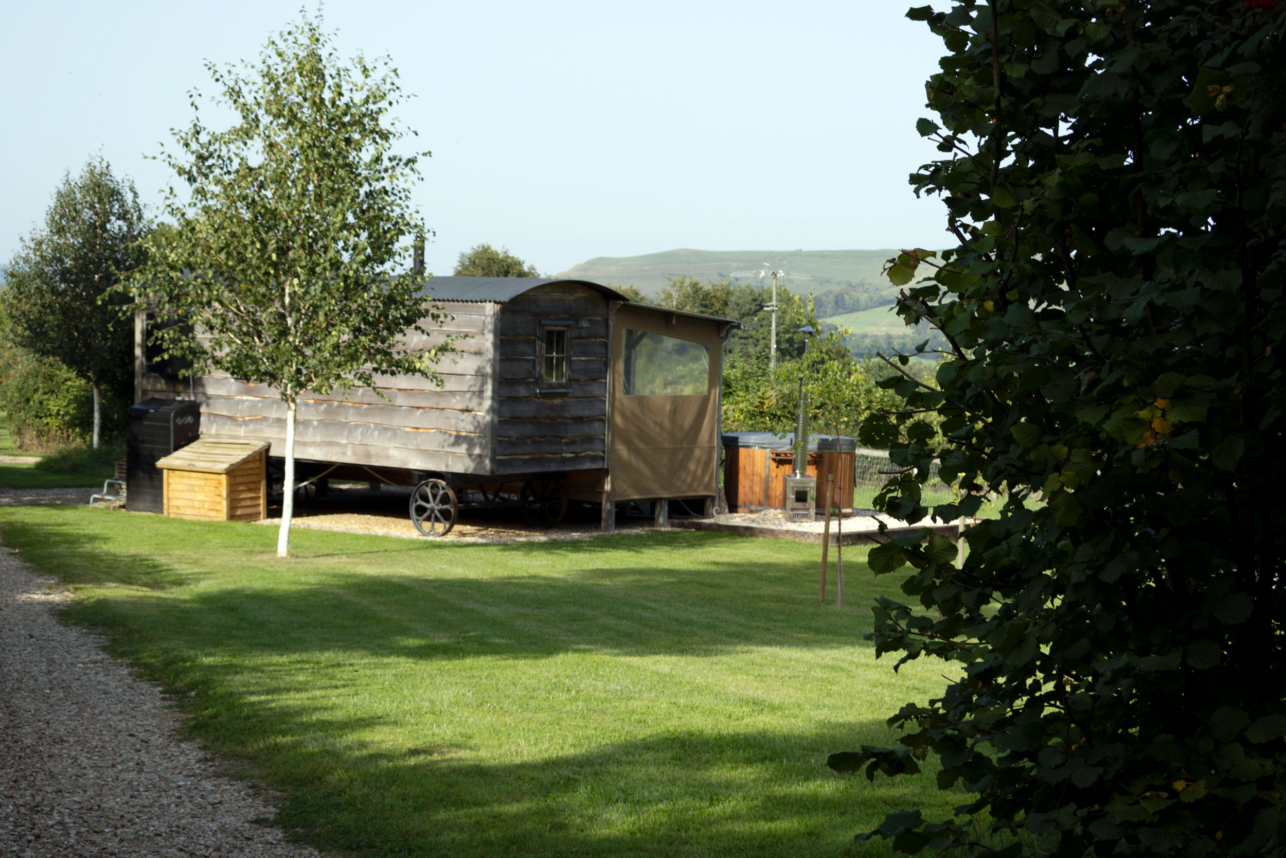 Rear view of Gold Panners Glamping cabin and hot tub at Loose Reins in Dorset