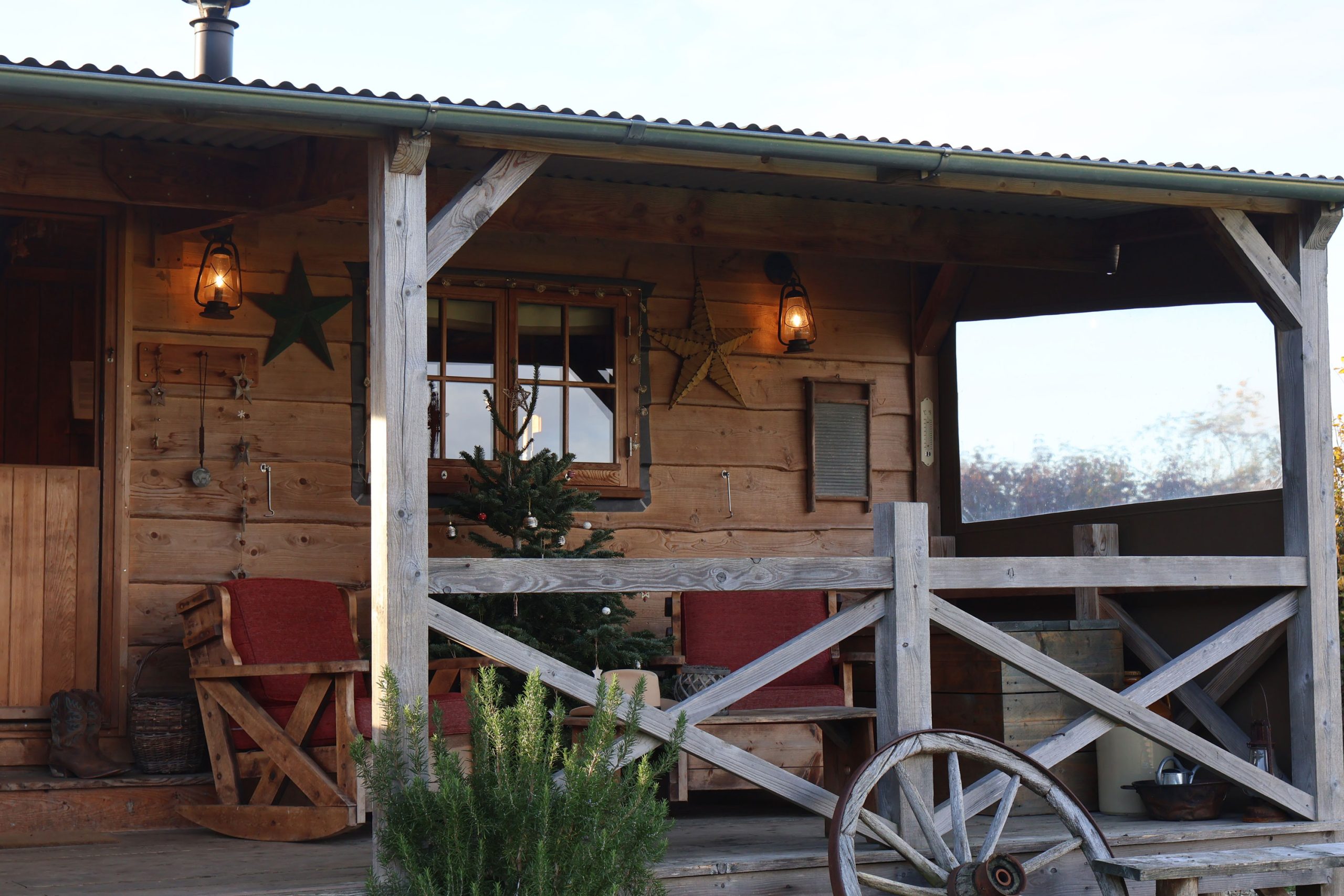 Exterior of rustic glamping cabin with Christmas Decorations