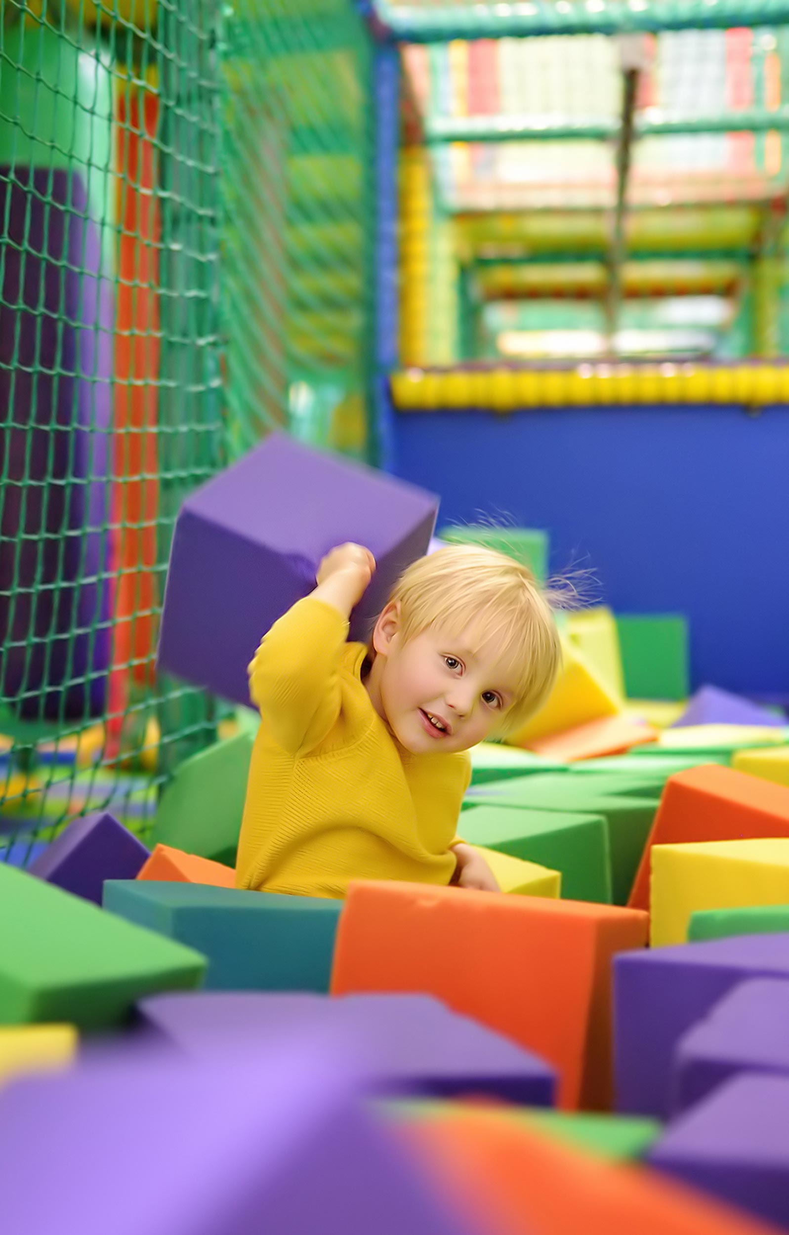 Toddler in a soft play area