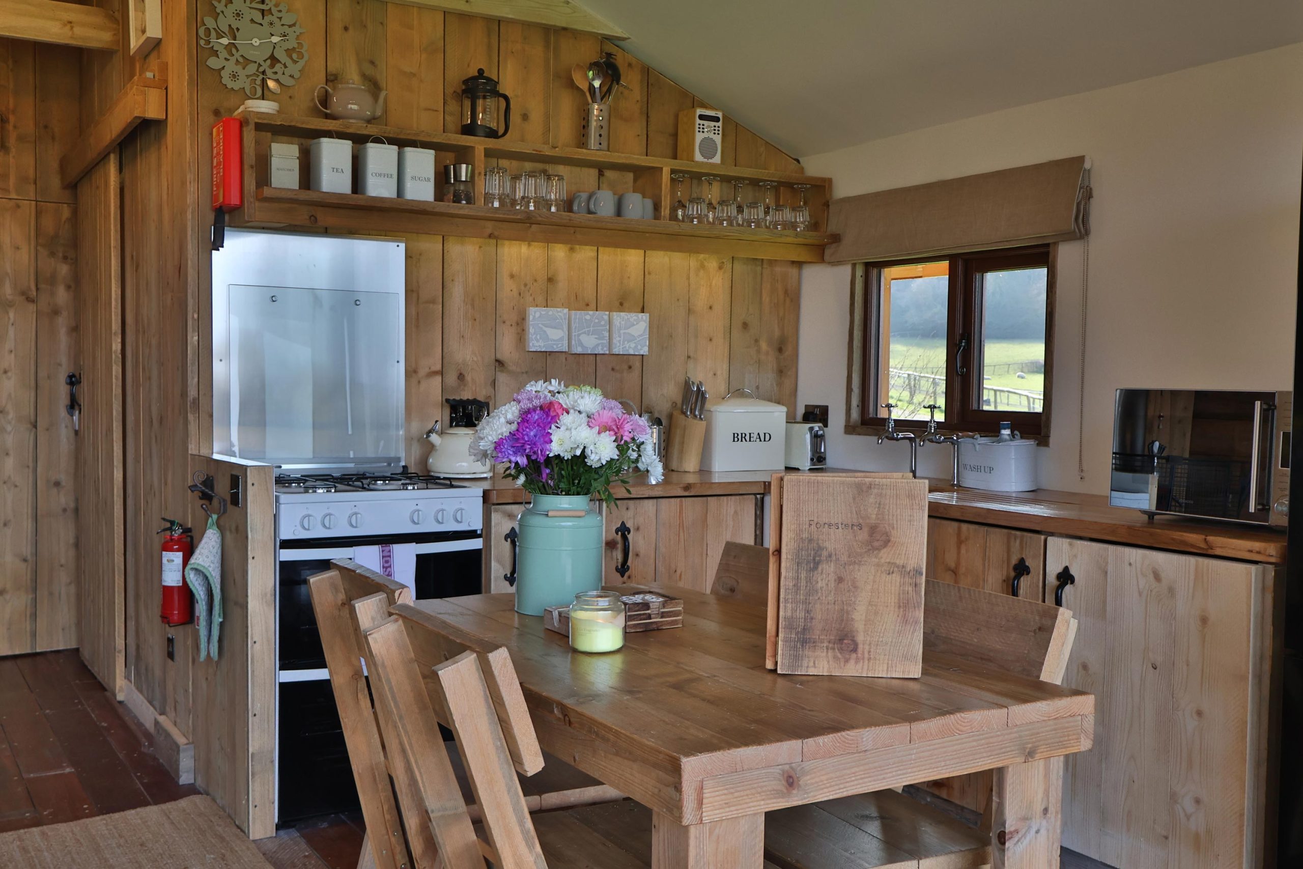 Beautiful wooden kitchen diner with hand crafted units and a table and chairs.
