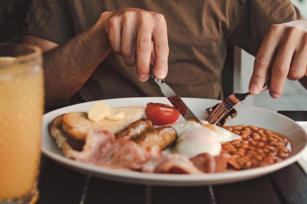 Man eating a full English breakfast